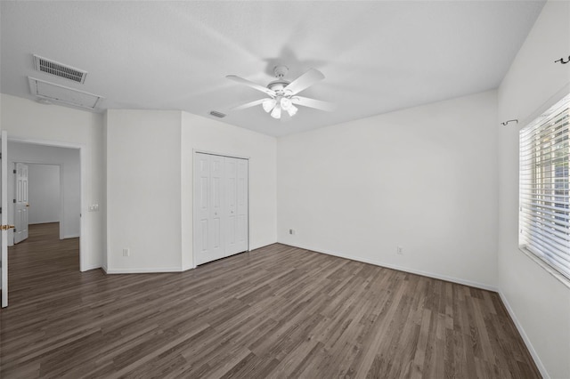 unfurnished room with baseboards, wood finished floors, visible vents, and ceiling fan