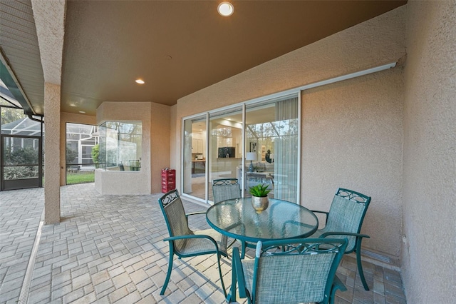 view of patio / terrace featuring glass enclosure