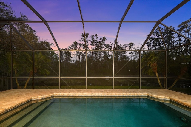 outdoor pool with a lanai and a patio