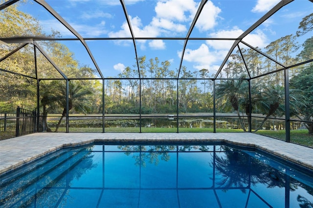 pool with glass enclosure and a patio