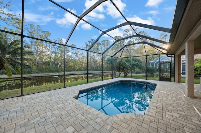 outdoor pool with glass enclosure and a patio area