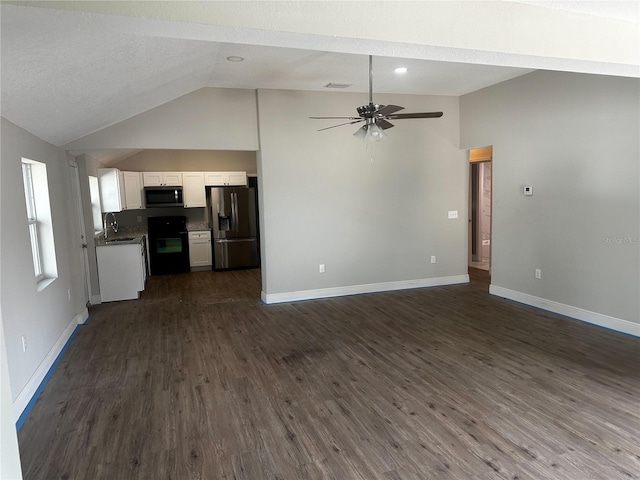 unfurnished living room with ceiling fan, baseboards, vaulted ceiling, and dark wood-style flooring