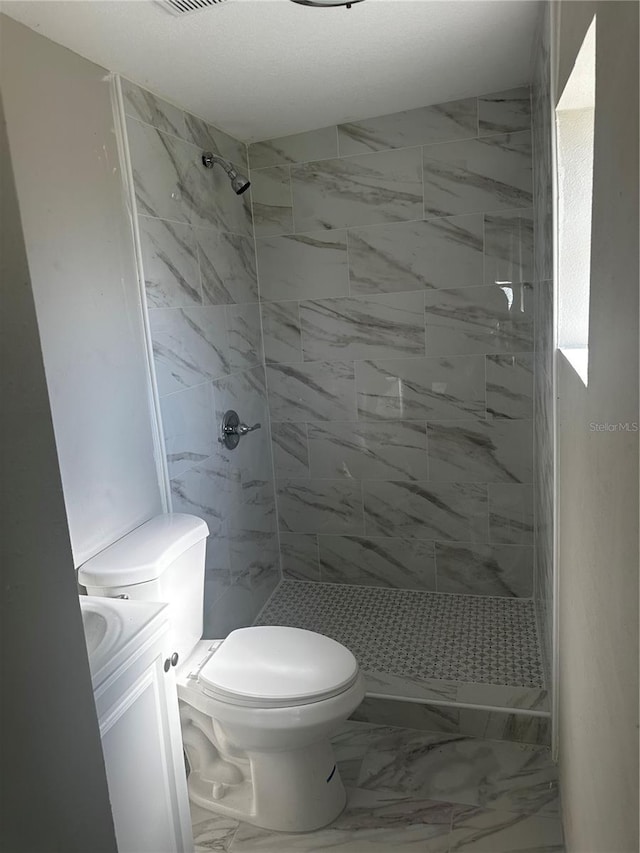 full bath with toilet, marble finish floor, a shower stall, and vanity