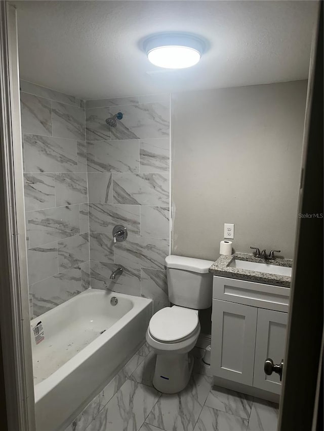 bathroom with marble finish floor, bathtub / shower combination, toilet, a textured ceiling, and vanity