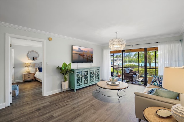 living area featuring baseboards, ornamental molding, wood finished floors, and an inviting chandelier