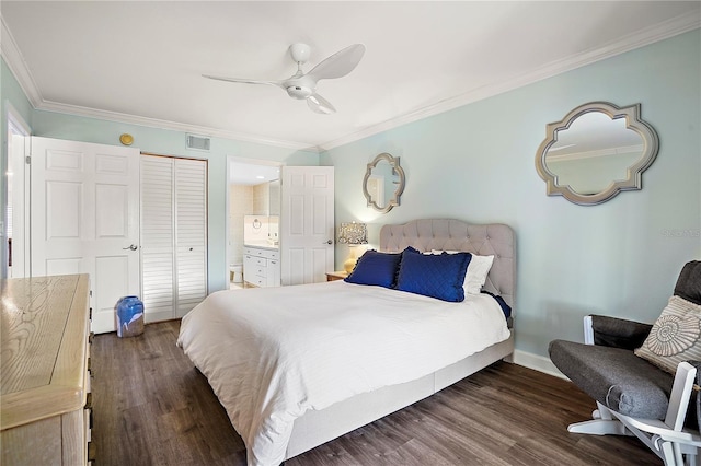 bedroom featuring visible vents, crown molding, ensuite bath, and wood finished floors