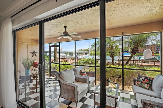 unfurnished sunroom featuring ceiling fan