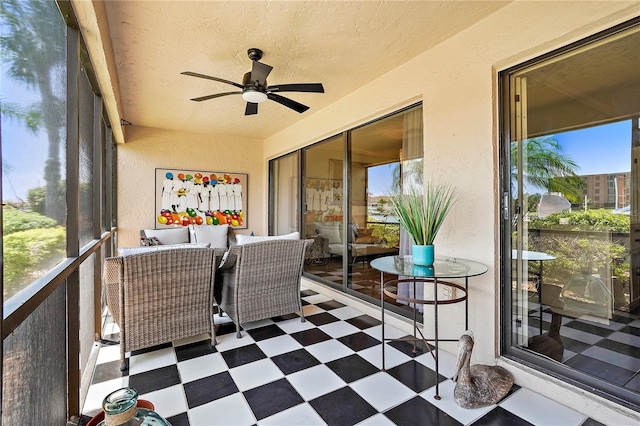 sunroom / solarium featuring ceiling fan