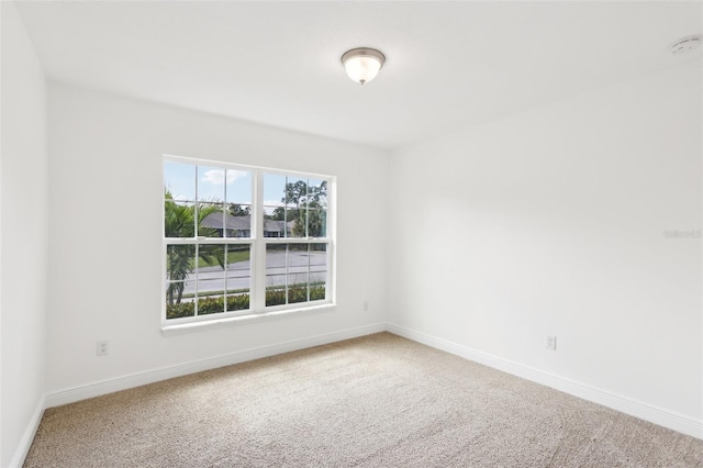 spare room with carpet floors and baseboards