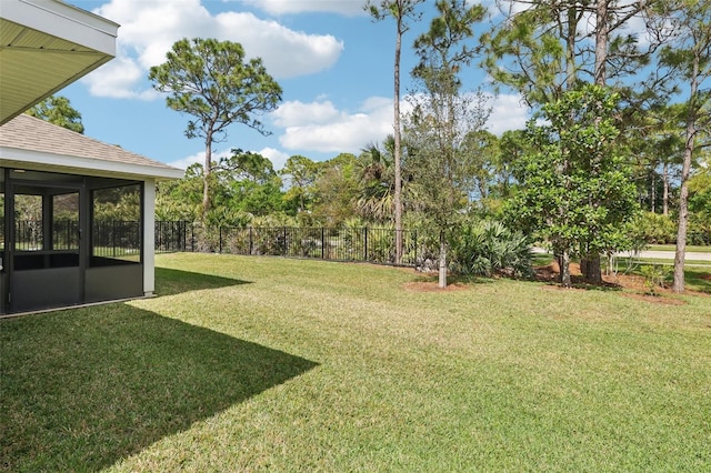 view of yard with a sunroom and fence