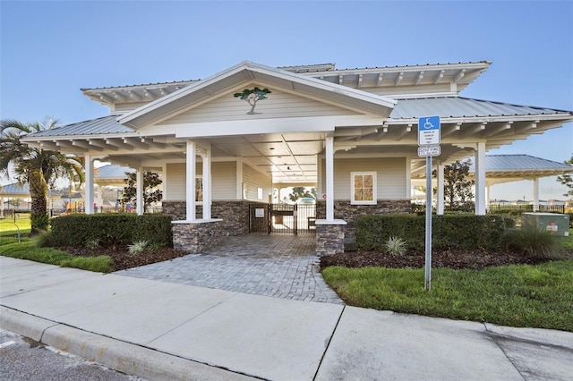 view of building exterior featuring a carport and driveway