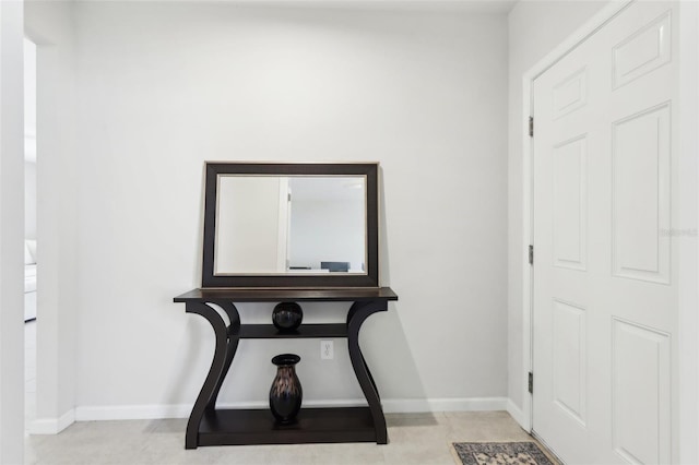 foyer featuring tile patterned floors and baseboards