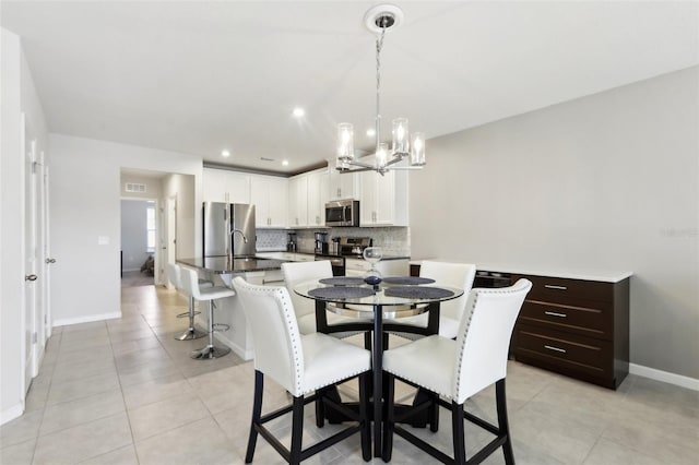 dining area with light tile patterned floors, baseboards, visible vents, a chandelier, and recessed lighting