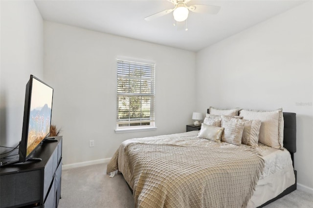 carpeted bedroom with baseboards and a ceiling fan