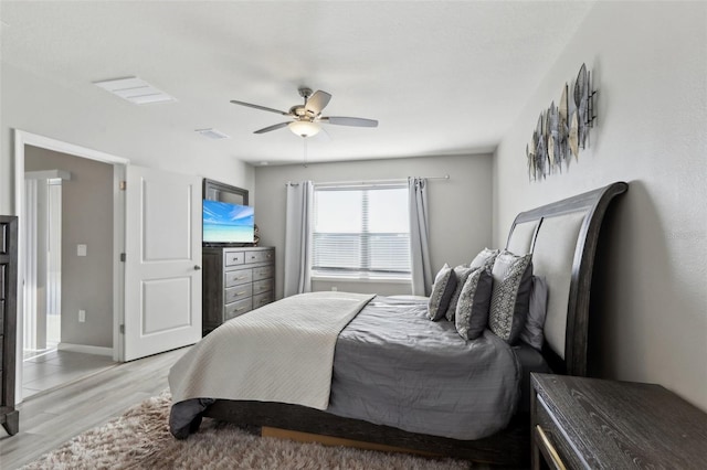 bedroom with visible vents, ceiling fan, light wood-type flooring, and baseboards