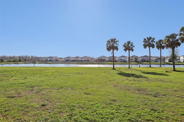 view of yard with a water view and a residential view