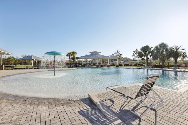 pool with a gazebo and a patio area