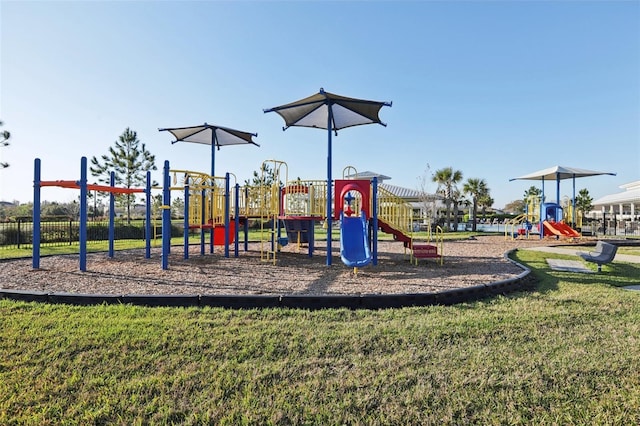 community jungle gym with a lawn