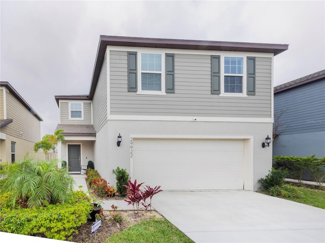 29922 Marquette Ave, Wesley Chapel, FL 33545 - traditional-style house featuring driveway, a garage, and stucco siding