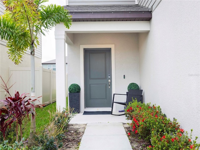 29922 Marquette Ave, Wesley Chapel, FL 33545 - entrance to property featuring roof with shingles, fence, and stucco siding