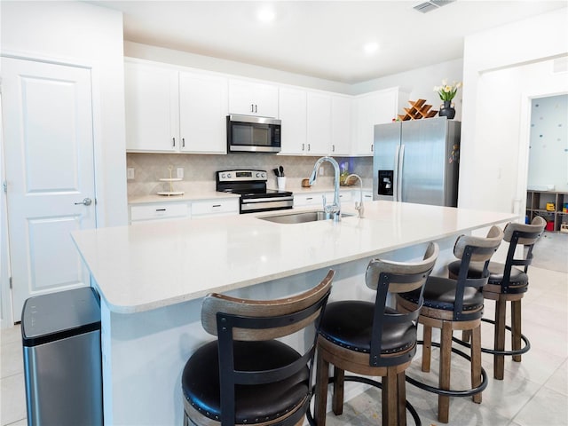 29922 Marquette Ave, Wesley Chapel, FL 33545 - kitchen featuring appliances with stainless steel finishes, light countertops, a sink, and decorative backsplash