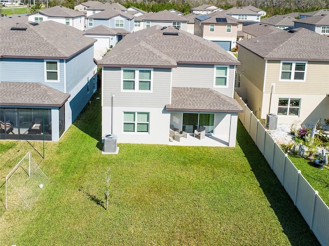 29922 Marquette Ave, Wesley Chapel, FL 33545 - back of house with a shingled roof, a fenced backyard, a residential view, central air condition unit, and a patio area