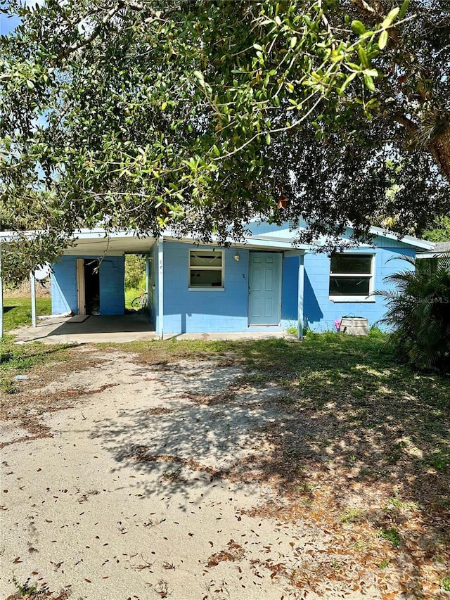 954 Fordson Ave, Labelle, FL 33935 - view of front of home featuring concrete block siding, an attached carport, and driveway