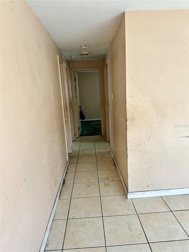 954 Fordson Ave, Labelle, FL 33935 - corridor featuring light tile patterned flooring, attic access, and baseboards