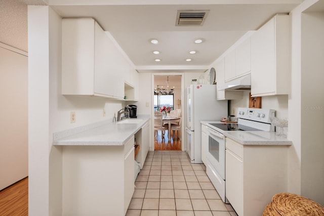 kitchen with visible vents, white electric range, under cabinet range hood, a sink, and light countertops