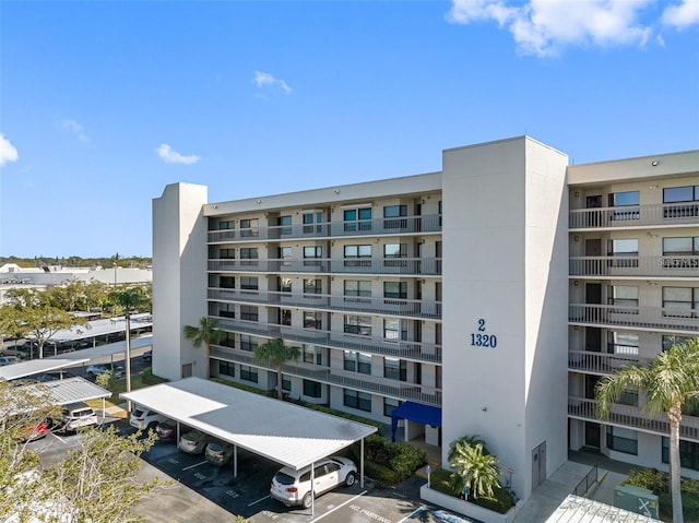 view of building exterior with uncovered parking