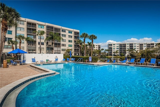 community pool featuring a patio and fence