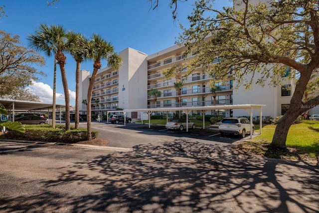 view of building exterior with covered parking