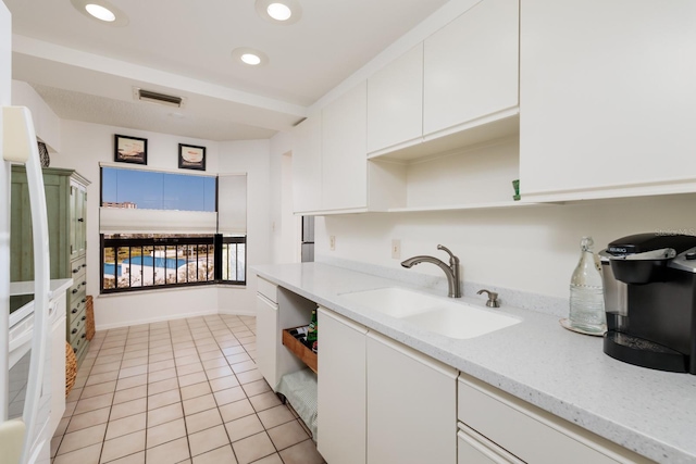 kitchen featuring light tile patterned floors, open shelves, recessed lighting, a sink, and white cabinets