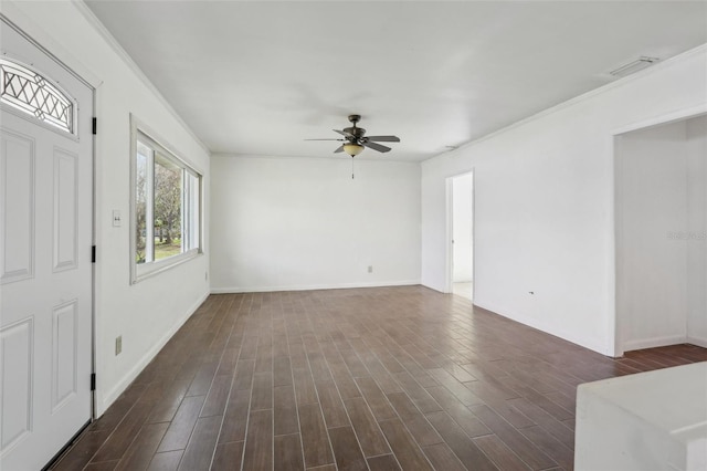 interior space with dark wood-style flooring, visible vents, ornamental molding, ceiling fan, and baseboards