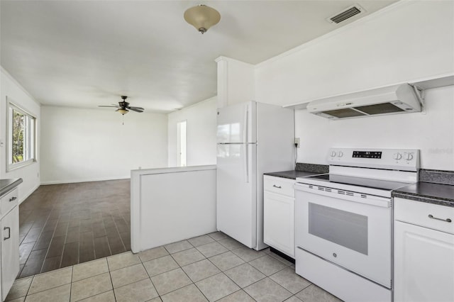 kitchen featuring dark countertops, white appliances, visible vents, and ventilation hood