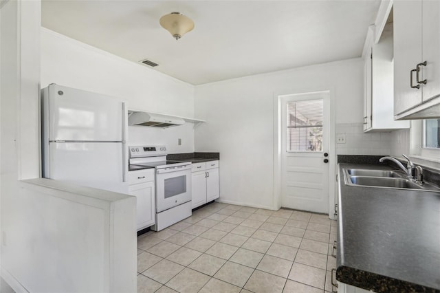 kitchen featuring dark countertops, white appliances, under cabinet range hood, and a sink