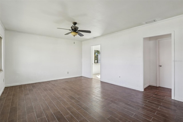 unfurnished room with dark wood-style floors, baseboards, visible vents, and a ceiling fan