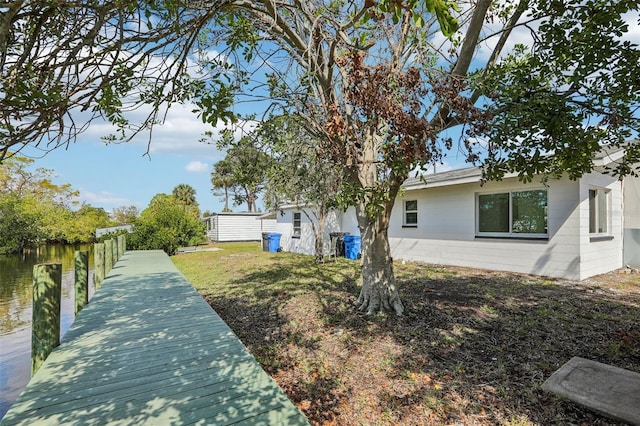 exterior space featuring a dock and concrete block siding