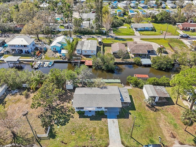 drone / aerial view with a water view and a residential view