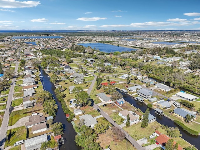 birds eye view of property with a water view and a residential view