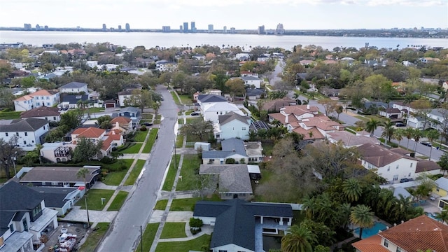 birds eye view of property with a water view and a residential view