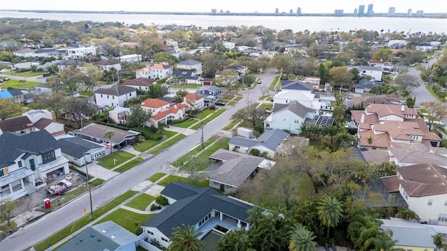 drone / aerial view with a water view and a residential view