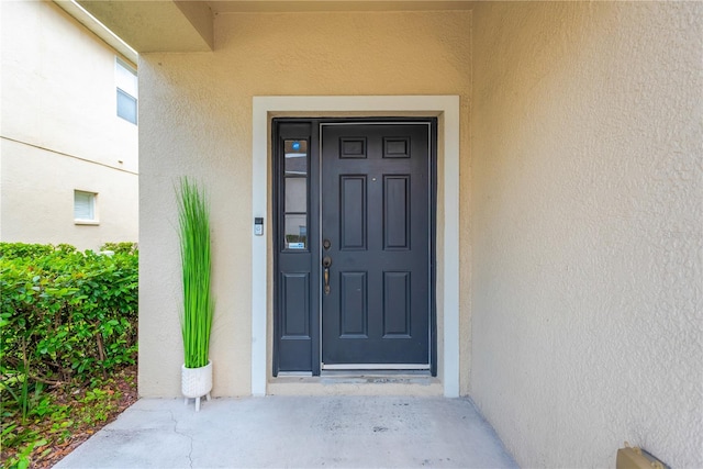 entrance to property with stucco siding