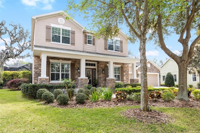 view of front facade with stone siding, a front lawn, and stucco siding