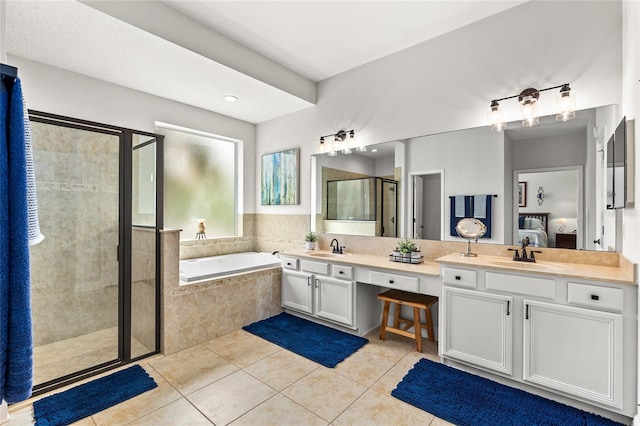 bathroom with a sink, a shower stall, ensuite bath, and tile patterned floors