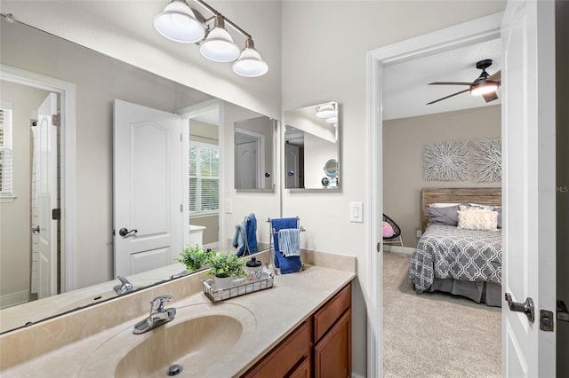 bathroom featuring ceiling fan, connected bathroom, vanity, and baseboards