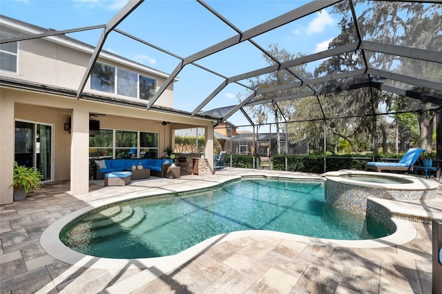 view of pool with a patio, a pool with connected hot tub, outdoor lounge area, glass enclosure, and ceiling fan