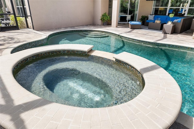 view of swimming pool with a patio, an outdoor living space, and a pool with connected hot tub