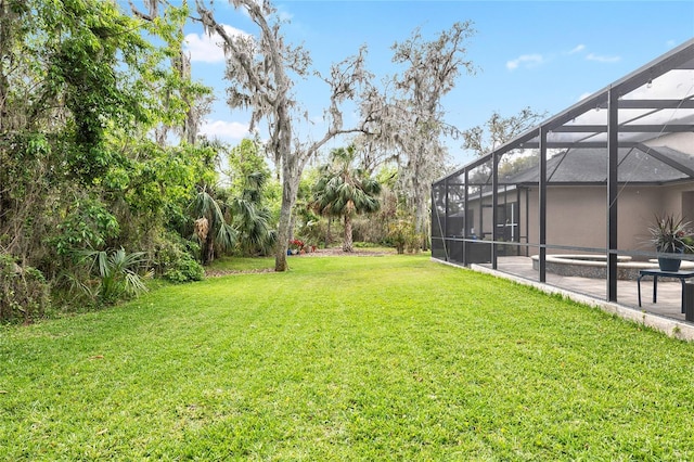 view of yard featuring a lanai, a swimming pool, and a patio