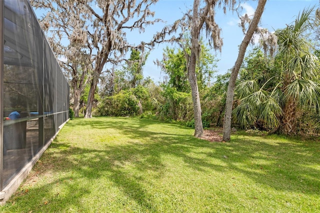 view of yard featuring glass enclosure